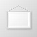 Realistic hanging on a wall blank white picture frame with shadow. Modern poster mockup isolated on gray background Royalty Free Stock Photo