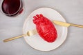 Realistic heart on the dining table in the plate