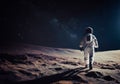 realistic illustration of astronaut walking on moon surface with milky way and space galaxy background