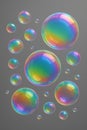 Realistic iridescent soap bubbles floating on a grey background Royalty Free Stock Photo