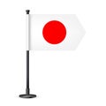 Realistic Japanese table flag on a black steel pole. Souvenir from Japan. Desk flag made of paper or fabric and shiny