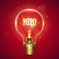 Realistic lamp with the inscription of 2020 year instead of the filament of incandescence, isolated on a red background Royalty Free Stock Photo