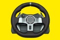 Realistic leather steering wheel isolated on a yellow background.