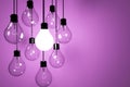 Realistic lightbulbs on pink background in 3D rendering