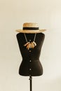 Realistic mannequin with a hat and a necklace