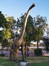 Realistic model of a dinosaur in the original growth. Park with sculptures of giant dinosaurs Royalty Free Stock Photo