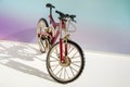 Realistic model of toy metal full-suspension mountain bike. Miniature bicycle on colored background