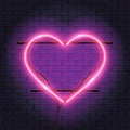 Realistic neon lamp in shape of heart, decoration on bricks wall Royalty Free Stock Photo