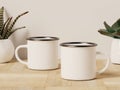 Two Camping Enamel Mugs with Succulent Plants in the Back