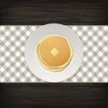 Realistic pancake with a piece of butter on a white plate closeup on wood background, top view. Design template for