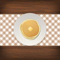 Realistic pancake with a piece of butter on a white plate closeup on wood background, top view. Design template for