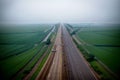 Realistic photo bird view of the empty highway through the fields in a fog Royalty Free Stock Photo