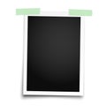 Realistic photo frame with straight edges placed vertically on white wall by two pieces of green adhesive tape. Vector template Royalty Free Stock Photo