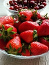 Realistic photo. Strawberries on a plate. Live.