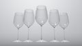 Realistic set of five transparent wine glasses.