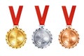 Realistic set of golden, silver, and bronze medals on red ribbons. Sports competition awards for 1st, 2nd, and 3rd place. Royalty Free Stock Photo