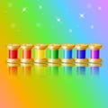 Realistic set of multi-colored spools of thread with mirror reflection on a colored background