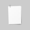 Realistic several sheets of paper and a metal paper clip isolated on background.