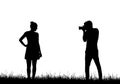 Realistic silhouette of a professional male photographer photographing a model woman in a dress on grass, vector
