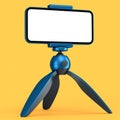 Realistic smartphone with blank white screen on blue tripod isolated on orange Royalty Free Stock Photo