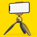 Realistic smartphone with blank white screen on gold tripod isolated on yellow Royalty Free Stock Photo