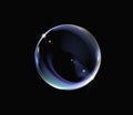 Realistic soap bubble with rainbow colors on black background. Royalty Free Stock Photo