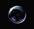 Realistic soap bubble with rainbow colors on black background. Royalty Free Stock Photo