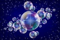 Realistic soap bubbles with rainbow reflection set isolated on the blue sparkling background. Royalty Free Stock Photo