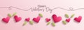 Realistic valentine day banner with green leaves and red heart shapes