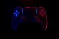Realistic video game controller in neon lights on black noir background