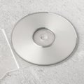 Realistic white cd template with box cover on white cement background.