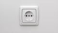 Realistic White Type F Socket on White Wall. Plastic Device for Access to Electric Power.