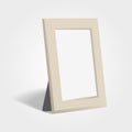 Realistic woden picture or photo frame mock up standing on light background.