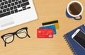 Realistic workplace with three credit cards concept of online payment and shopping