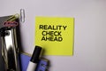 Reality Check Ahead on sticky notes isolated on white background Royalty Free Stock Photo