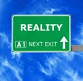 REALITY road sign against clear blue sky Royalty Free Stock Photo