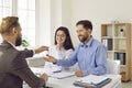 Realtor giving key to new apartment to young couple Royalty Free Stock Photo