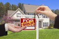 Realtor Handing Over the House Keys in Front of New Home