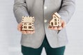 realtor holding house figurines. High quality photo