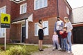 Realtor Outside House For Sale With Young Family