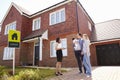 Realtor Outside House For Sale With Young Family Royalty Free Stock Photo