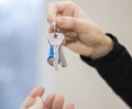 The realtor passes the keys to the apartment to the clients.the concept of selling or renting a home Royalty Free Stock Photo