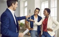 Realtor or real estate agent gives keys to new house to happy young black couple Royalty Free Stock Photo