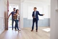 Realtor Showing Hispanic Couple Around New Home Royalty Free Stock Photo