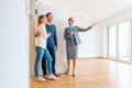 Realtor showing house to a young couple