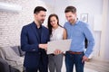 Realtor Showing New House To Couple In Laptop Royalty Free Stock Photo