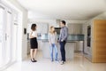 Realtor Showing Young Couple Around Property For Sale