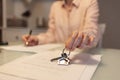 Realtor shows keys and signing documents. Close-up of hands. Concept of leasing and mortgage Royalty Free Stock Photo