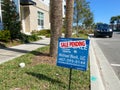 A realtor sign in front of a condo that says Sale Pending