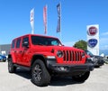Red Jeep Wrangler Sahara in show outside the Fiat Chrysler Automobiles automaker group dealership of the area.